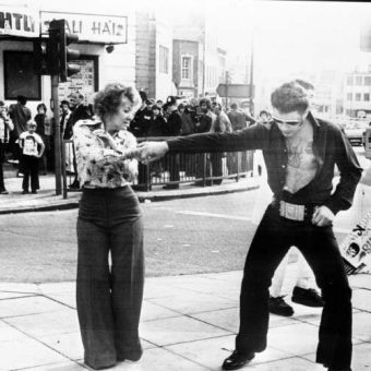Elvis Presley Fans Dance On A Traffic Island Outside The Palais De Danse Hall in Nottingham