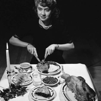 December 1942: Miss Virginia Hammel of McLeod County, Minn. Tucks Into The Typical American Christmas Dinner